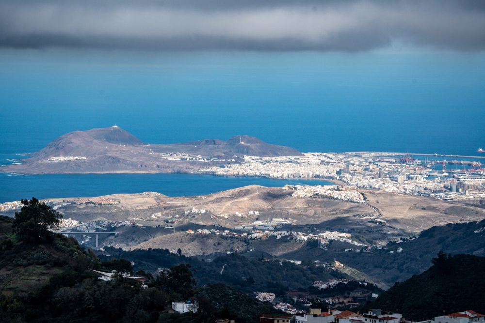 Elevated view of Las Palmas with floating clouds and ocean