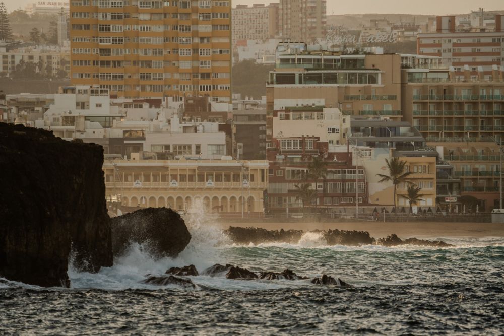 Las Palmas buildings over beach with ocean and rocks