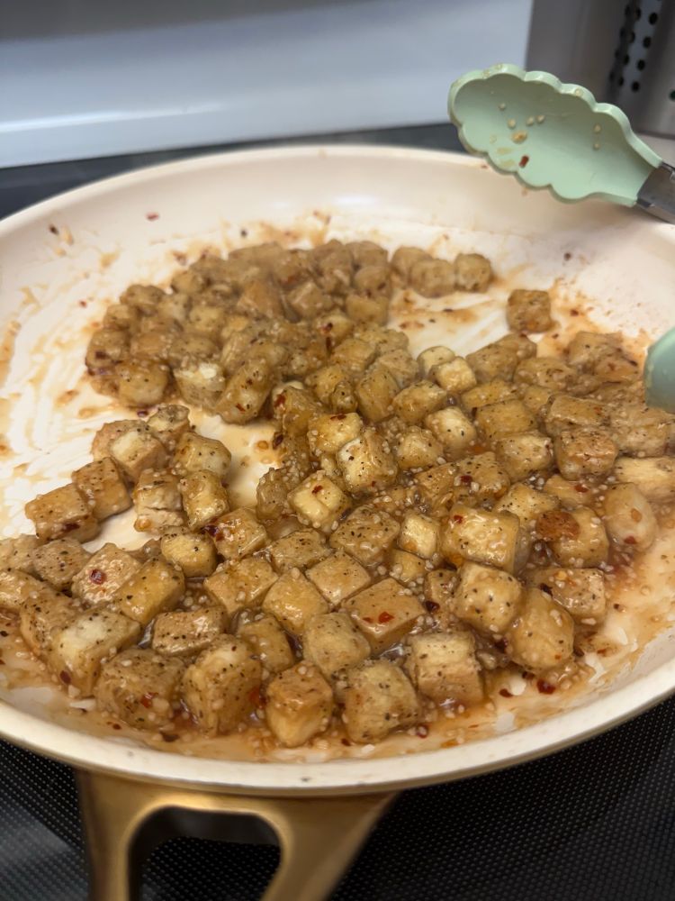 A close up of fried tofu in a pan