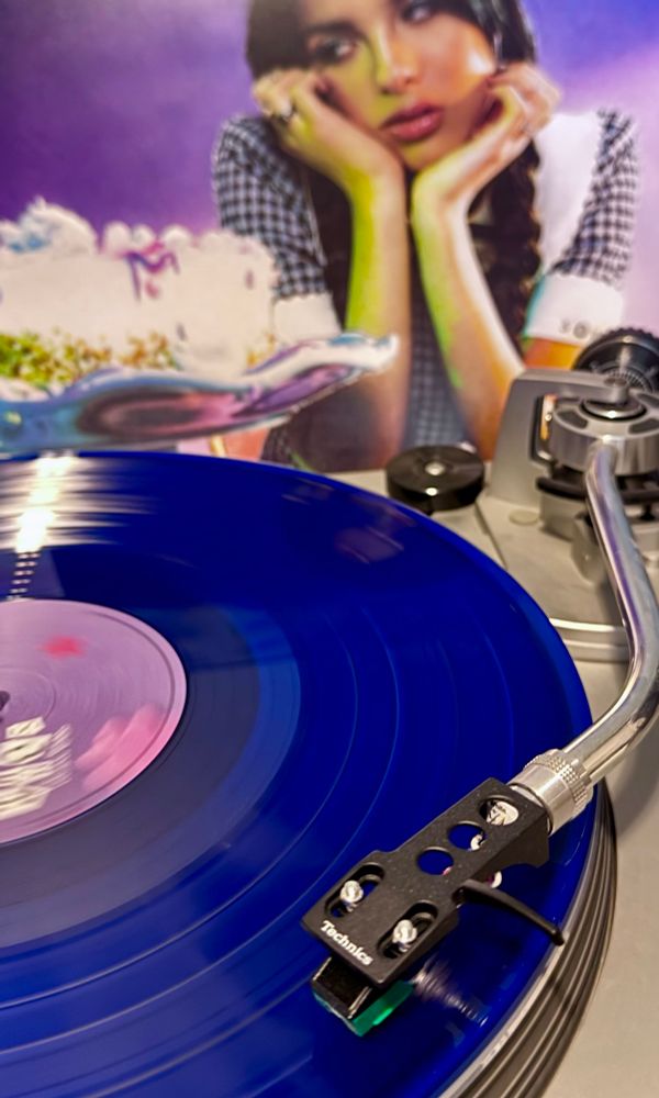Bright blue record playing on a turntable. 