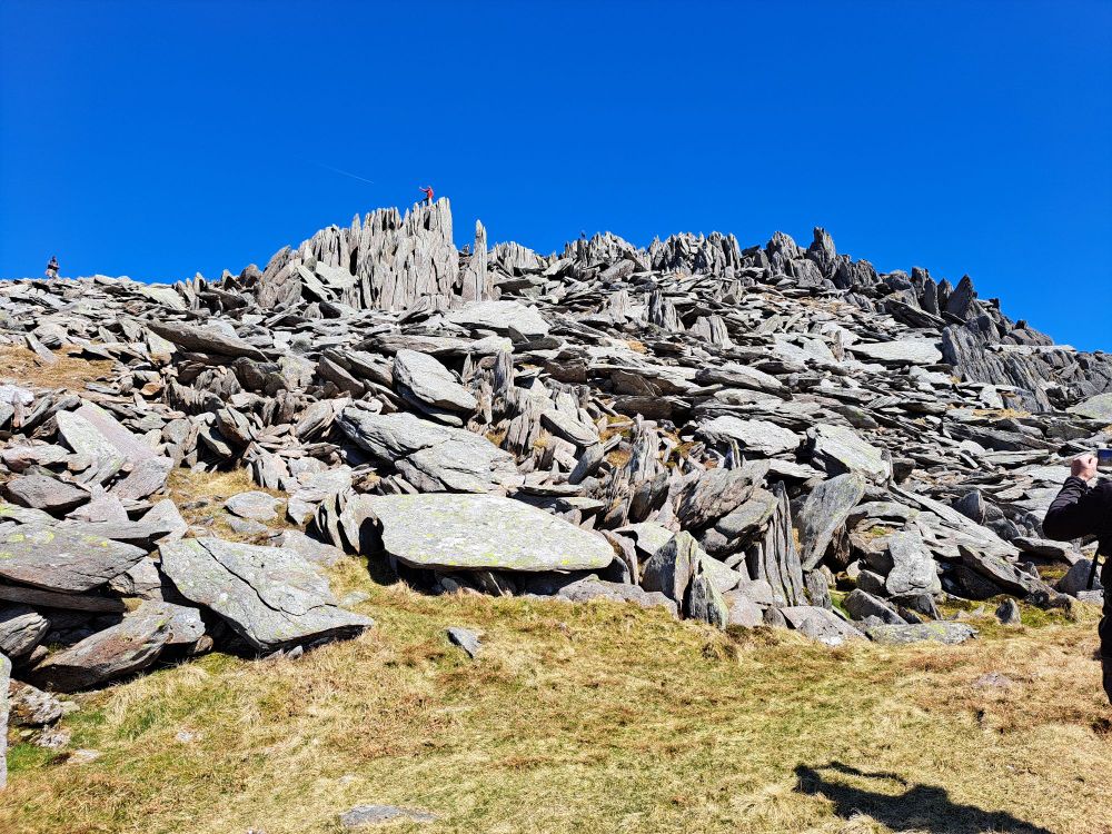 Spiky rocks and boulders on the approach to Castell y Gwynt, random people dotted about