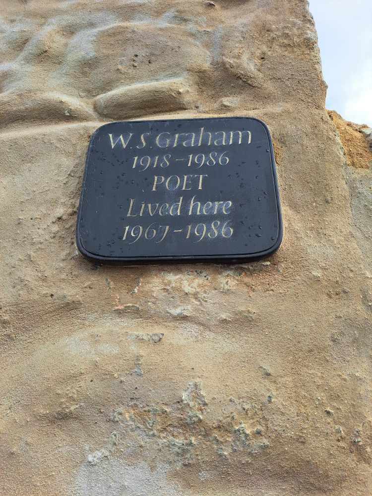 Carved slate plaque on a stone wall. W.S.Graham 1918 - 1986 POET Lived here 1967 - 1986.