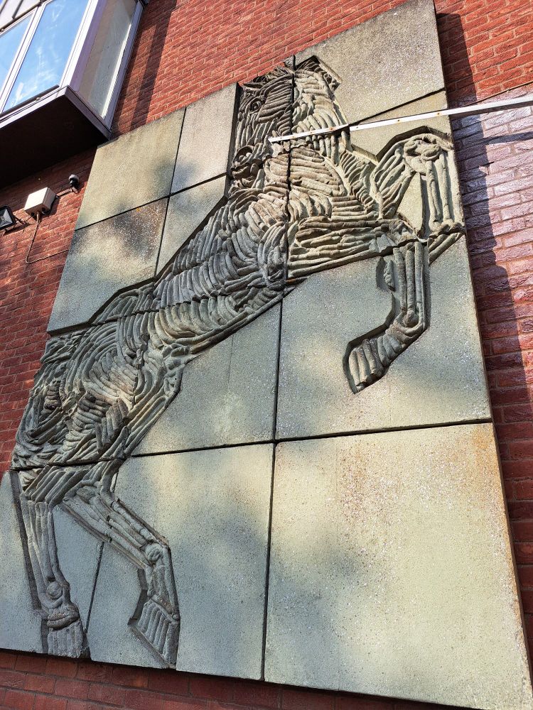 concrete relief mural of yet another horse
