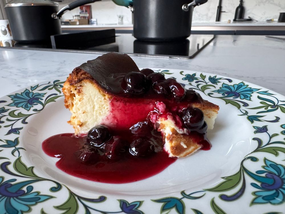 Slice of a baked cheesecake with blueberry sauce 