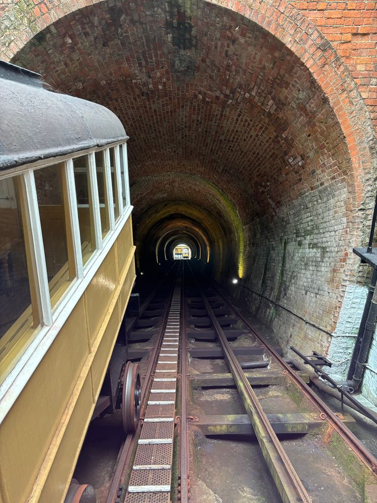 A view down the funicular from the top station, showing the tunnel and one of the carriages on the left.