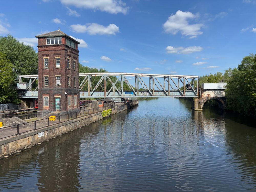A side-on view of Barton swing aqueduct crossing the Manchester Ship Canal, with the control tower on the left on the island.