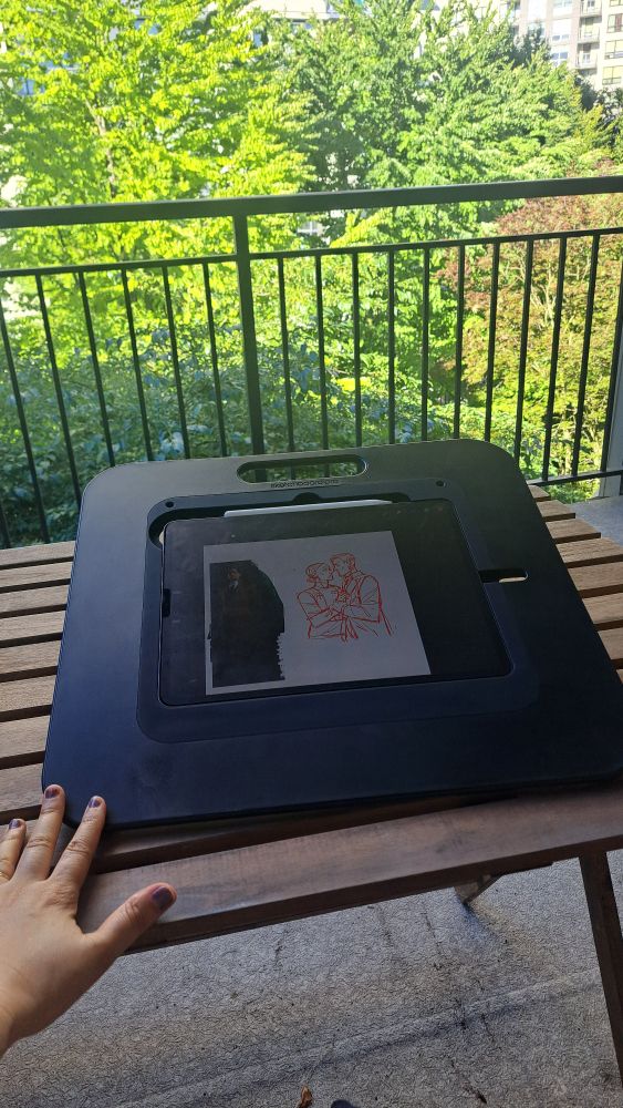Ipad pro inside a Sketchboard pro, a human hand patting it approvingly
