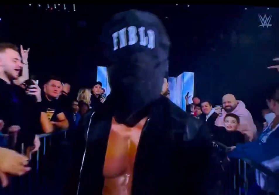 Pro wrestler Finn Balor wearing a black hood over his head for some reason 
