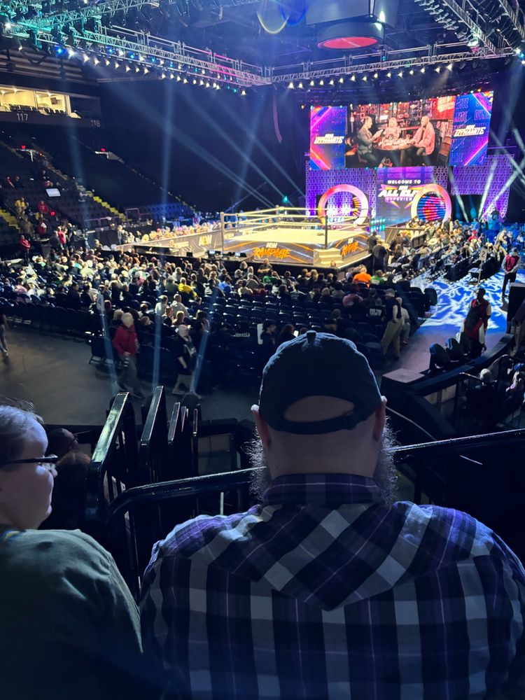 The interior of an arena showing an empty wrestling ring