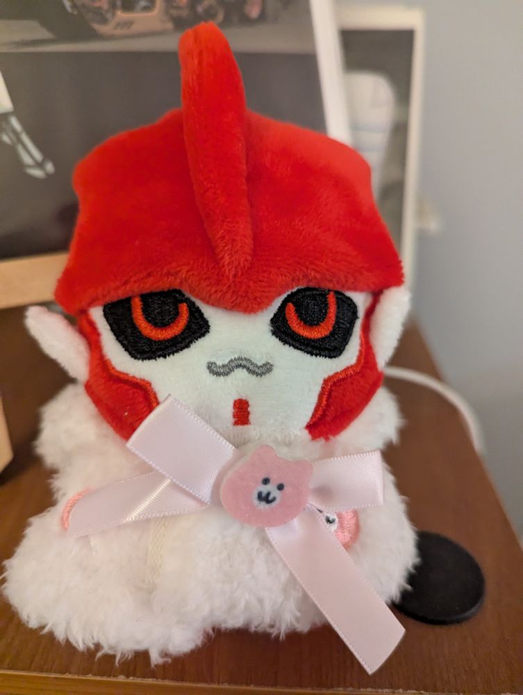 Knockout from Transformers Prime Plushie wearing a Chiikawa poncho without the hood on