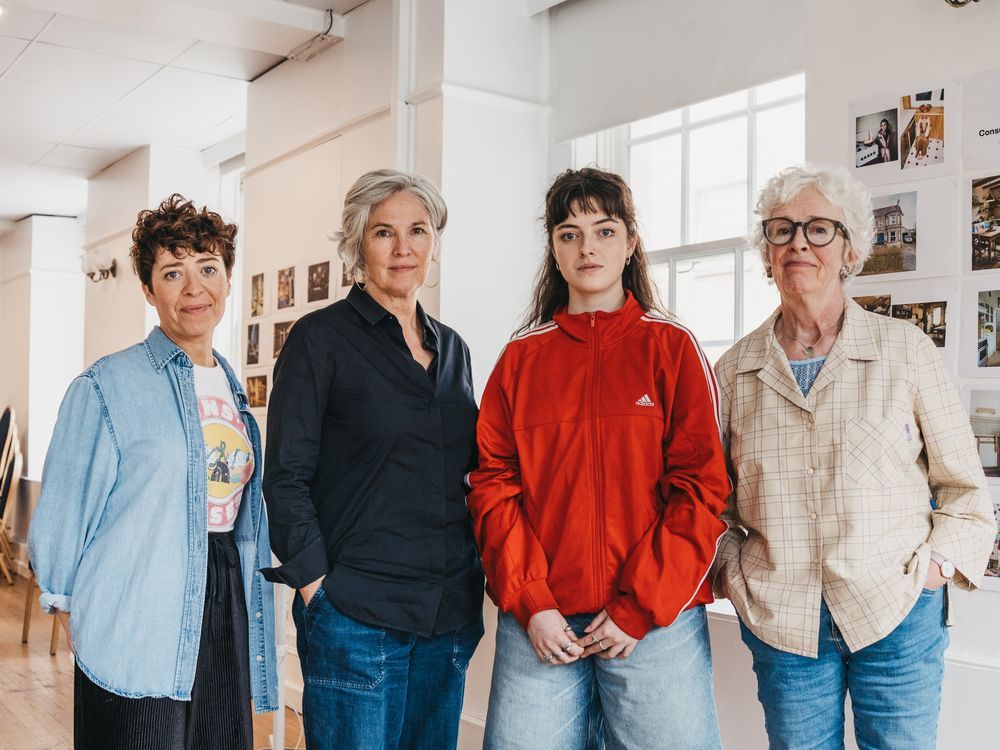 Four people wearing casual clothing stand together in a bright rehearsal room. Caoimhe, Andrea, Muireann, Julia - Consumed cast (photo Greta Zabulyte)