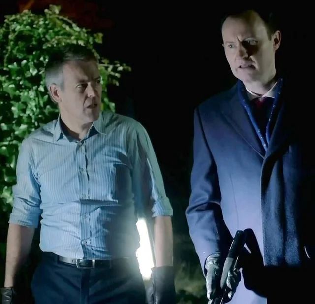 Greg Lestrade (Rupert Graves) and Mycroft Holmes (Mark Gatiss)