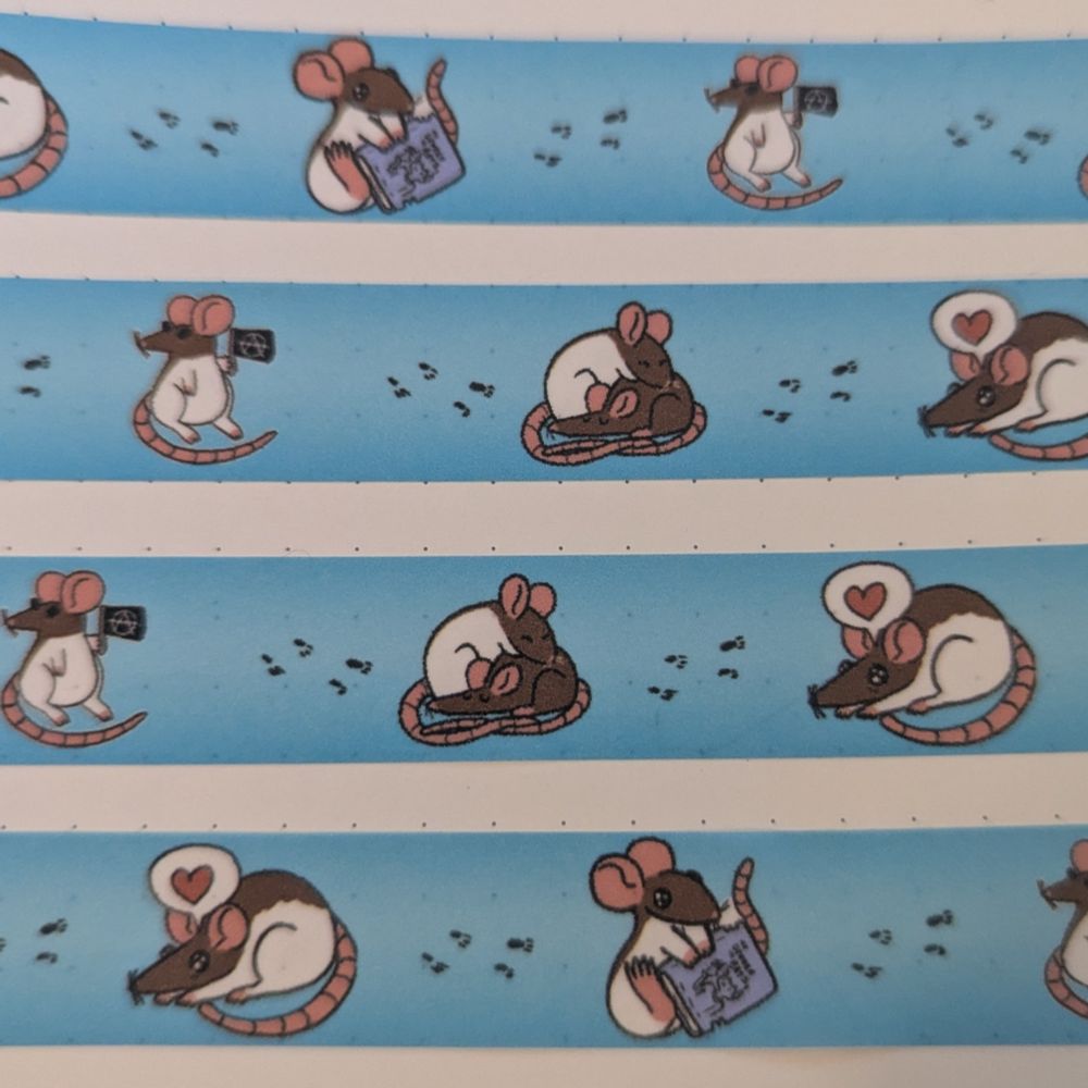 A photograph of some washi tapes featuring rats on a blue background 
