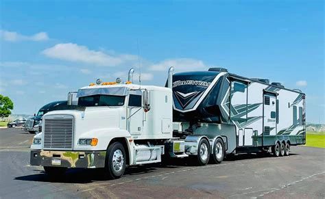 A picture of an RV with like 6 wheels per side