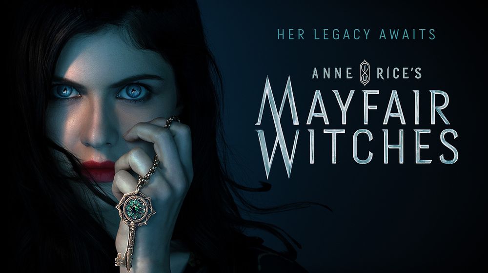 pale skinned white woman with bright green eyes against a shadowy dark blue backdrop, holding a key on a chain in her hand, as she touches her face. The woman has long black hair slightly obscuring the left hand side of her face, and bright red lipstick. There is text: Her legacy awaits. Anne Rice’s Mayfair Witches