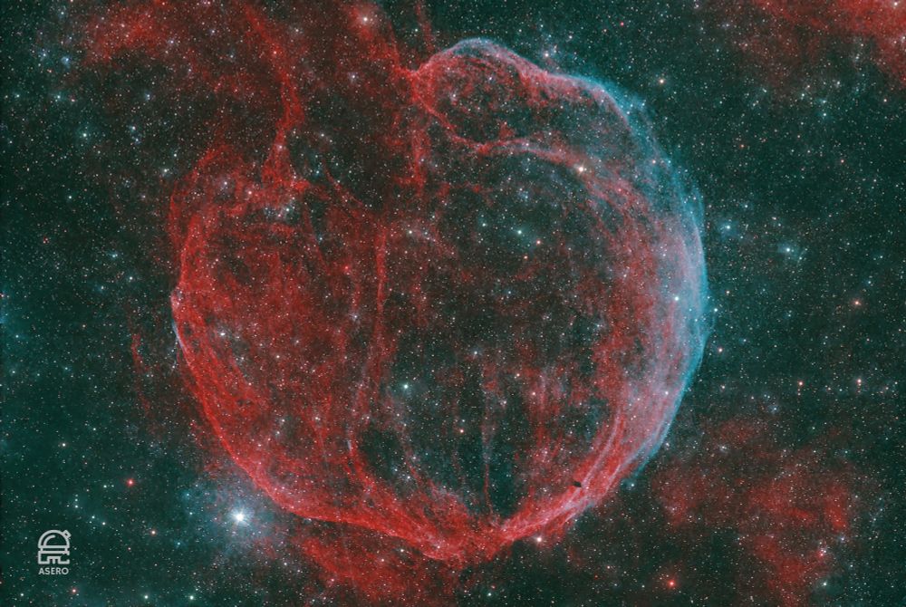 LBN 576, also known as the Popped Balloon Nebula.  It's a faint supernova remnant in Cassiopeia with a diameter of around 98 light years.  The image shows tendrils of red (hydrogen-alpha) and blue (oxygen-iii) looking somewhat like a balloon with the neck pointing to the upper left.