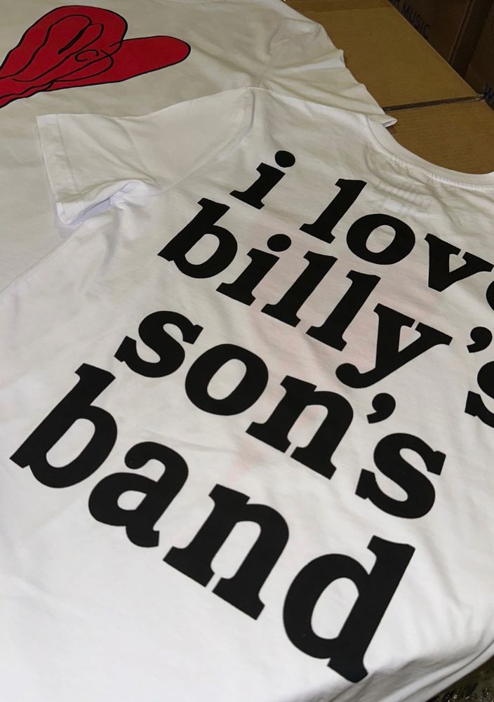 a white tee with big black letter’s that say “i love billy’s son’s band.” on the other side is a red heart design that mimics the smashing pumpkins’ logo but it says MCR in the center instead of SP