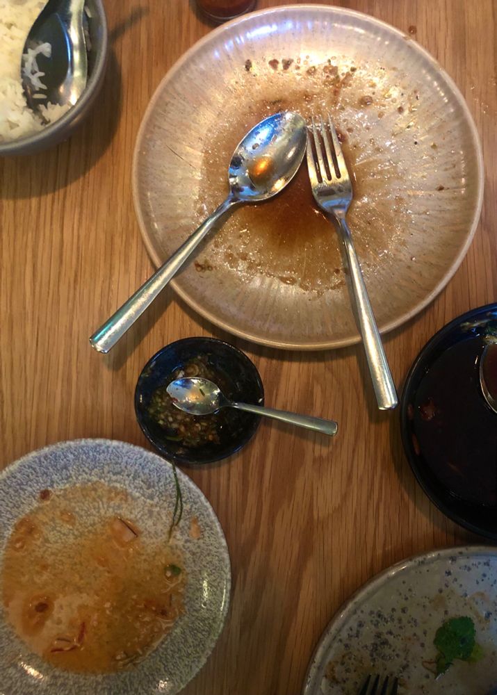 A table adorned with empty plates following an amazing meal at Boon Nam, Helsinki.