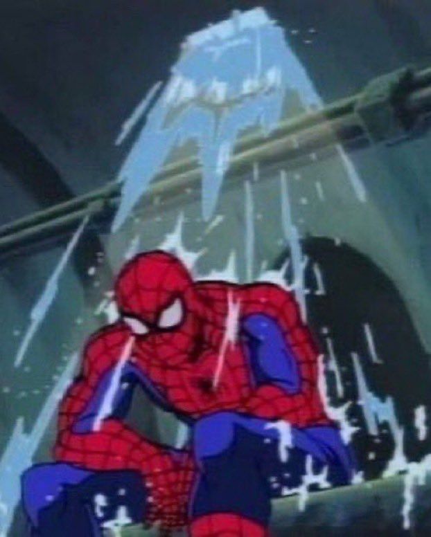 Spider-Man sitting in the sewers with water pouring over him. He looks defeated or tired