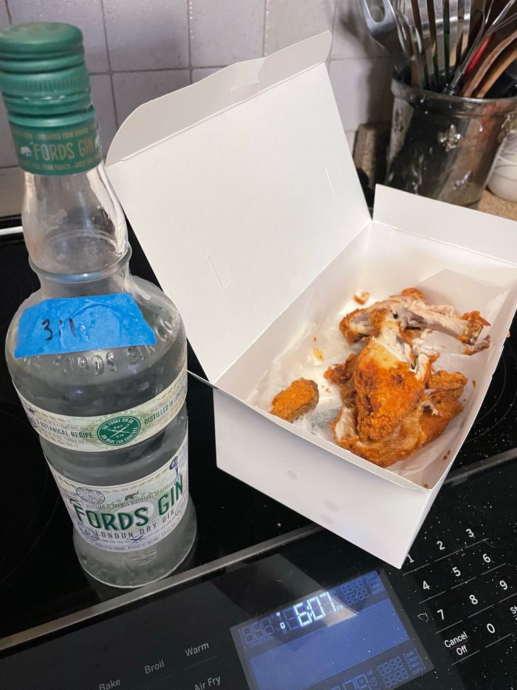 A bottle of Ford’s gin martini (3:1) and a box gas station fried chicken 