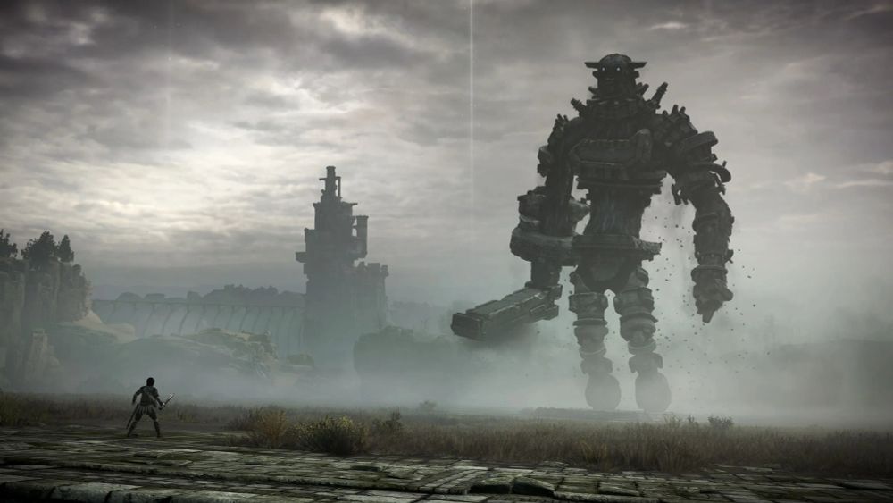 A screenshot from Shadow of the Colossus, with the tiny player on the left and a huge colossus - twenty times their height - standing up on the right