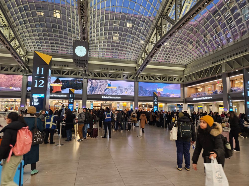 Hundreds of people just standing in Moynihan Hall 