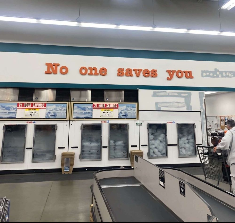 Broken grocery store interior signage that reads 'no one saves you'. 