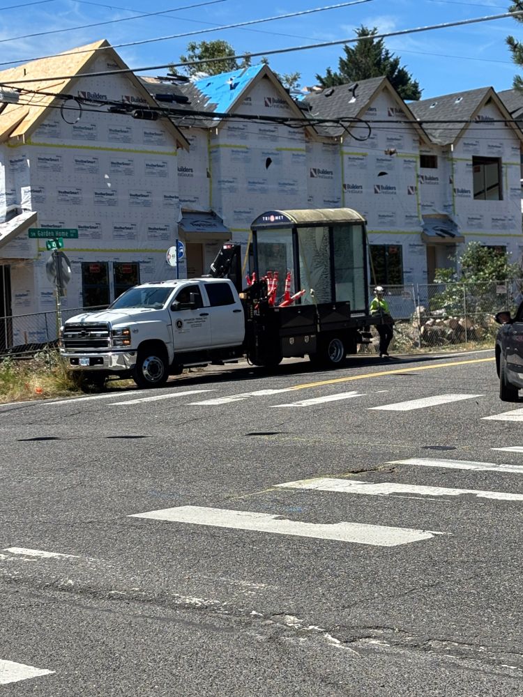 Trimet contractors haul away the bus shelter so that stop #1958 can be closed permanently.