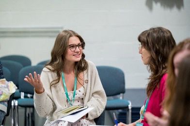 Two delegates chatting at a previous IMC