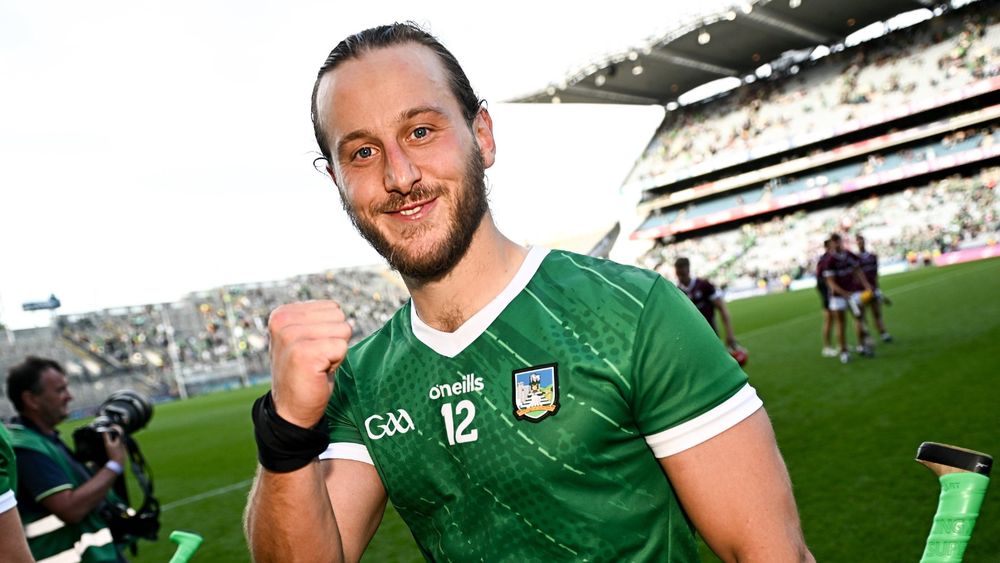 Limerick hurler and UL graduate, Tom Morrissey, celebrates in Croke Park. He is wearing a green Limerick jersey and has his fist up in celebration.