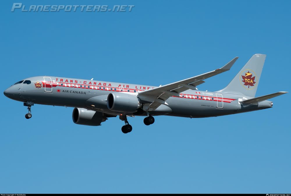 Grey Airbus A220 with a red and yellow stripe along the windows and retro style Trans Canada script and leaf logo on the tail 