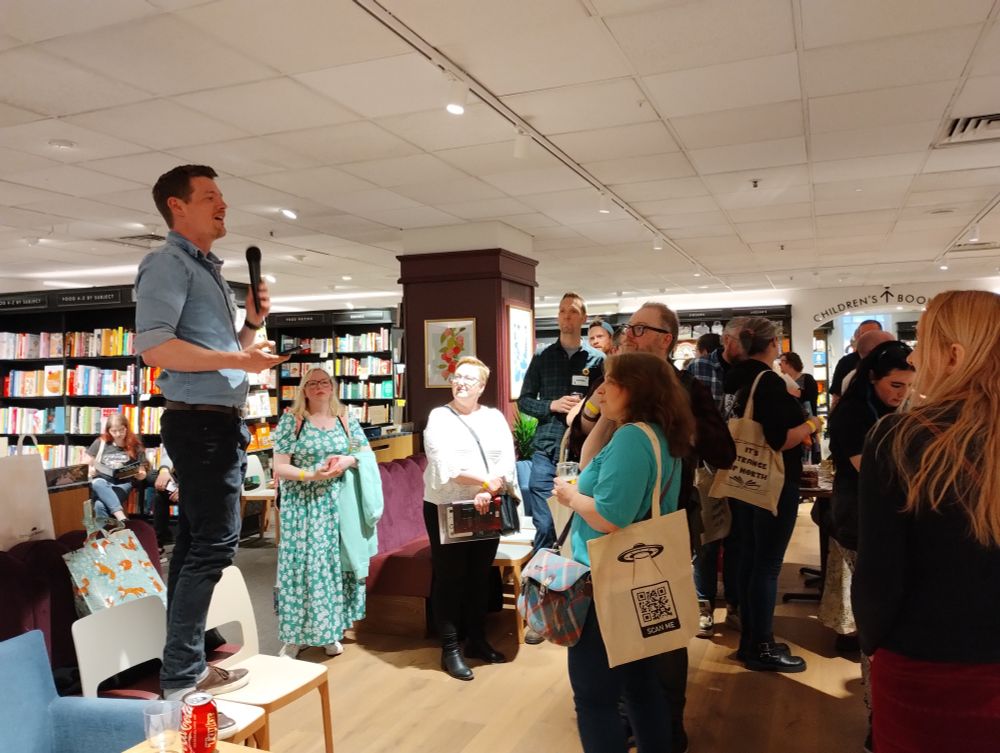 Nicholas Binge stood on a chair with a microphone talking to the crowd