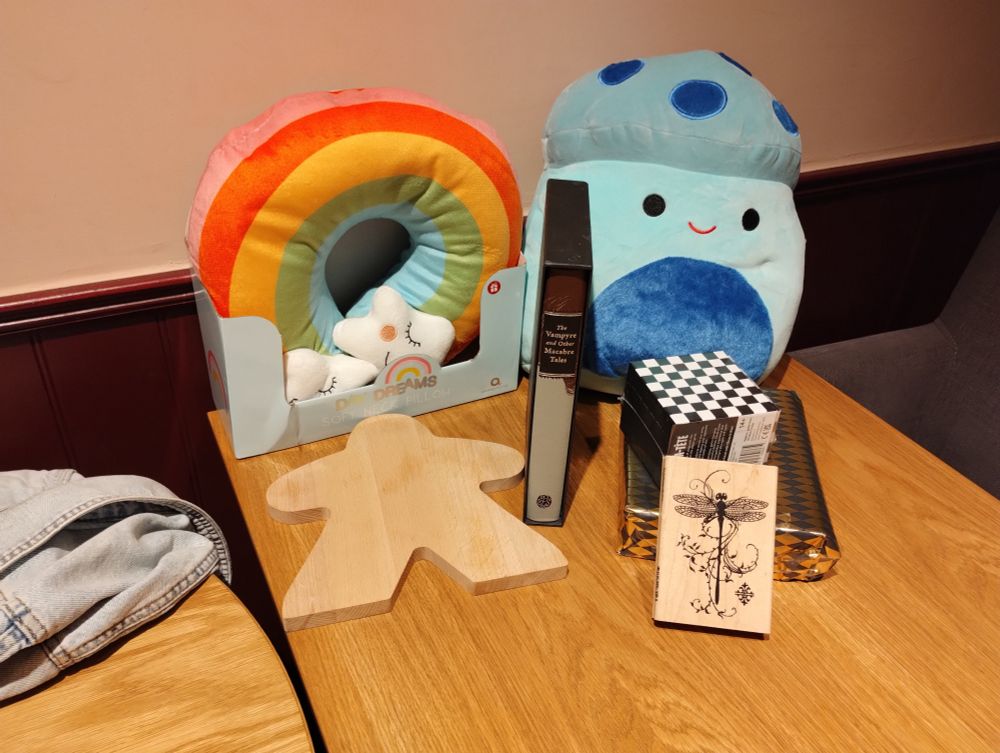The prizes for the bingo - soft toys, a hardback book, a game, a stamp, wrapped up bottles of whiskey