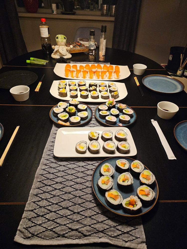 Table with several plates of sushi. 