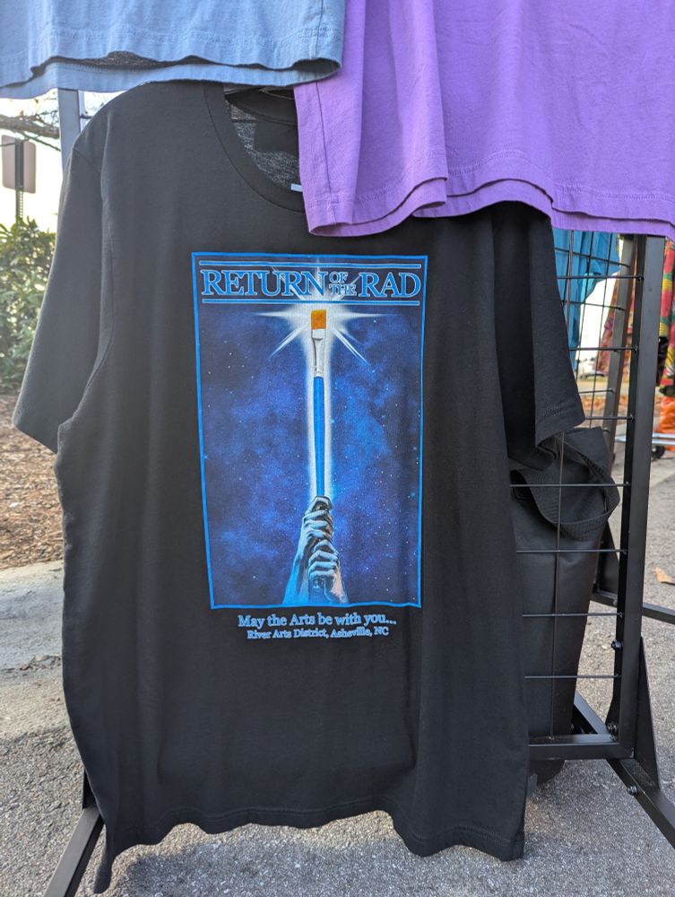 A Tshirt printed with "Return of the RAD" and a Return of the Jedi motif with a paintbrush in place of a light saber