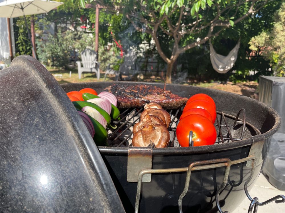 Tri-tip, tomatoes, onions, jalapeños and mushrooms on a Weber grill