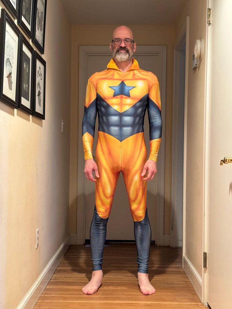 Man in Booster Gold costume, with no head covering and a flared collar. Front view 