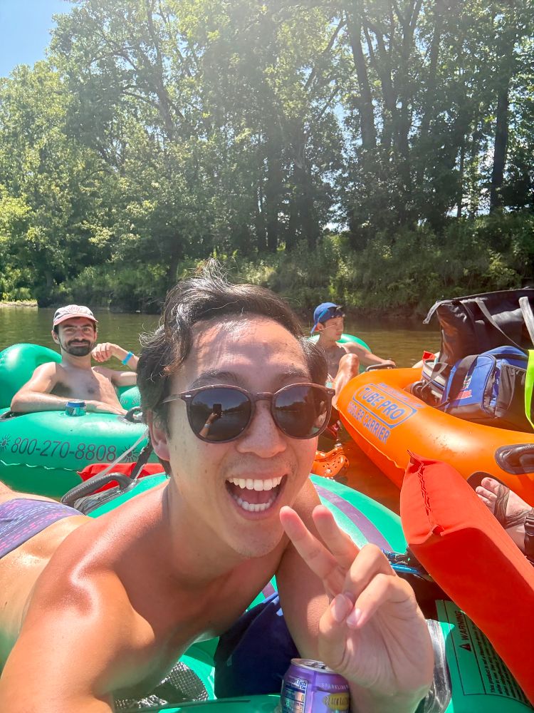 Floating on a river in green tubes and a orange tube holding coolers