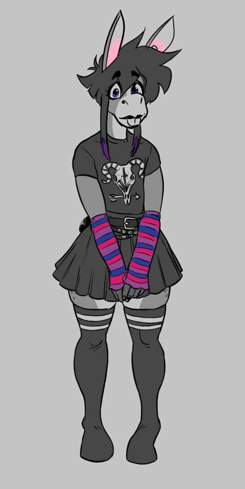 Pixie in a black t-shirt with a horned ram skull and arrow design on it, a black pleated skater skirt, black thigh-high socks with white stripes at the top, a few belts, and striped armlets in the colors of the bisexual flag: blue, pink, and purple.