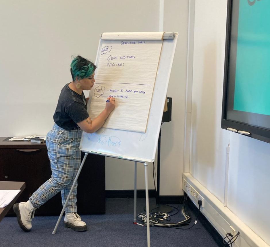 Sarah writing some words on some flipchart paper.