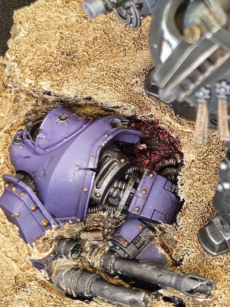 Iron Hands Contemptor Dreadnought stands above a destroyed Emperor's Children Dreadnought.