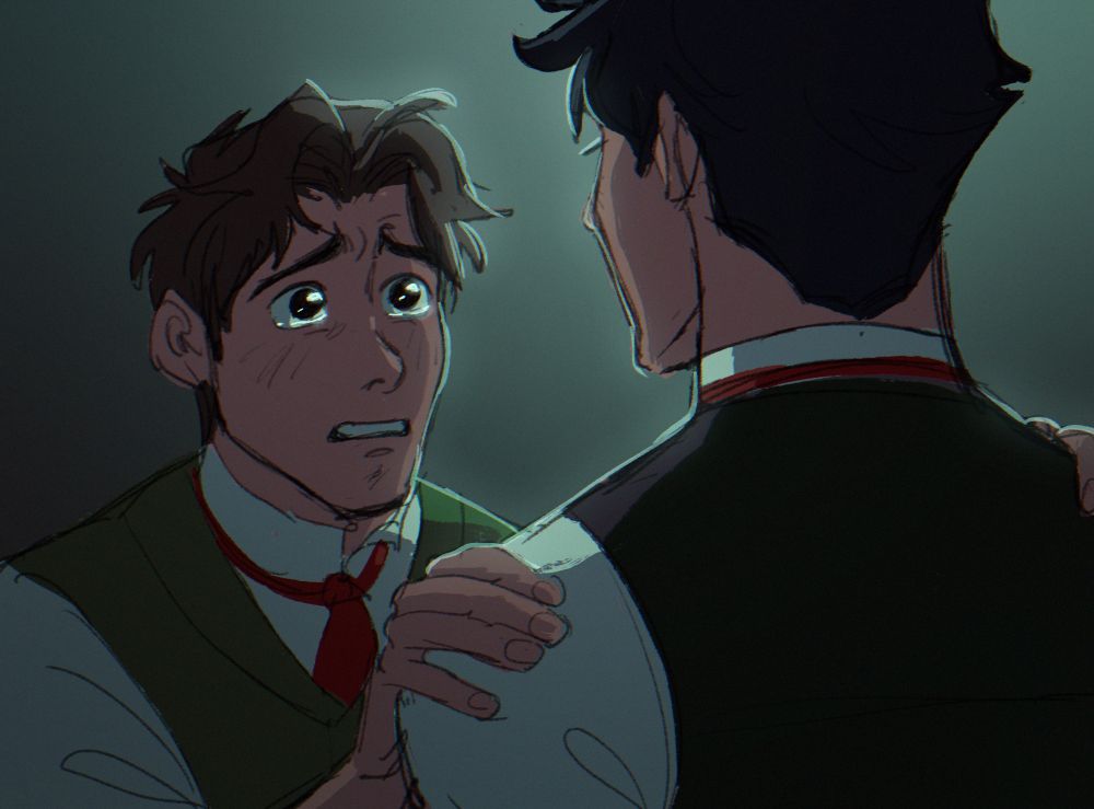 Two young men stand against a dark background. They are dressed in Victorian era wear. The one facing the camera is tearful and pleading as he grips the second man's shoulders.