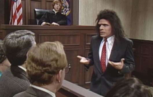 The image shows Phil Hartman playing Unfrozen Caveman Lawyer on SNL.