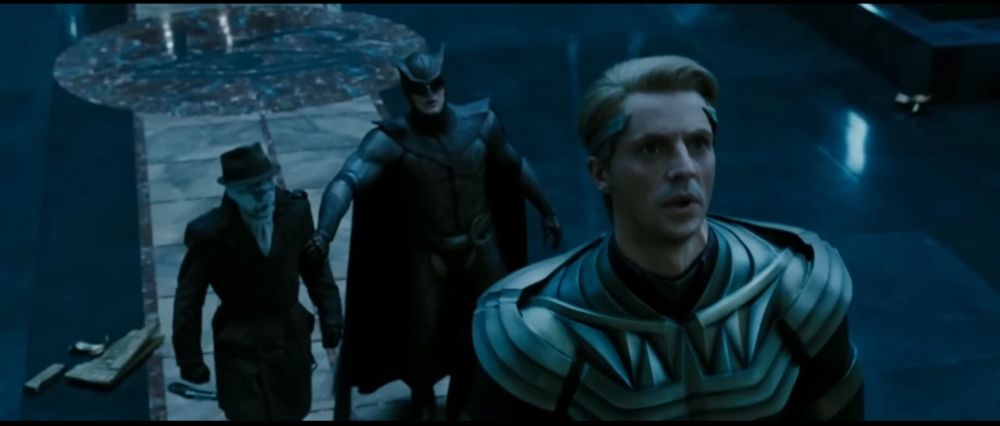 the image shows rorschach, niteowl, and ozymandias from the movie "watchmen" as ozymandias explain that he already launched his master plan and nothing can stop it.