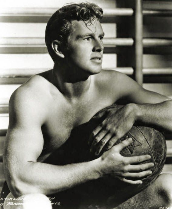 The b&w image is of a shirtless Sterling Hayden in a gym, holding a medicine ball.