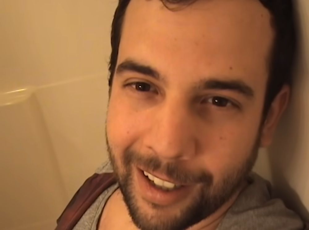 Screenshot from the film RAP WORLD (2024) showing Jason (Eric Rahill) addressing the camera while in the bathroom of Casey's mom's house