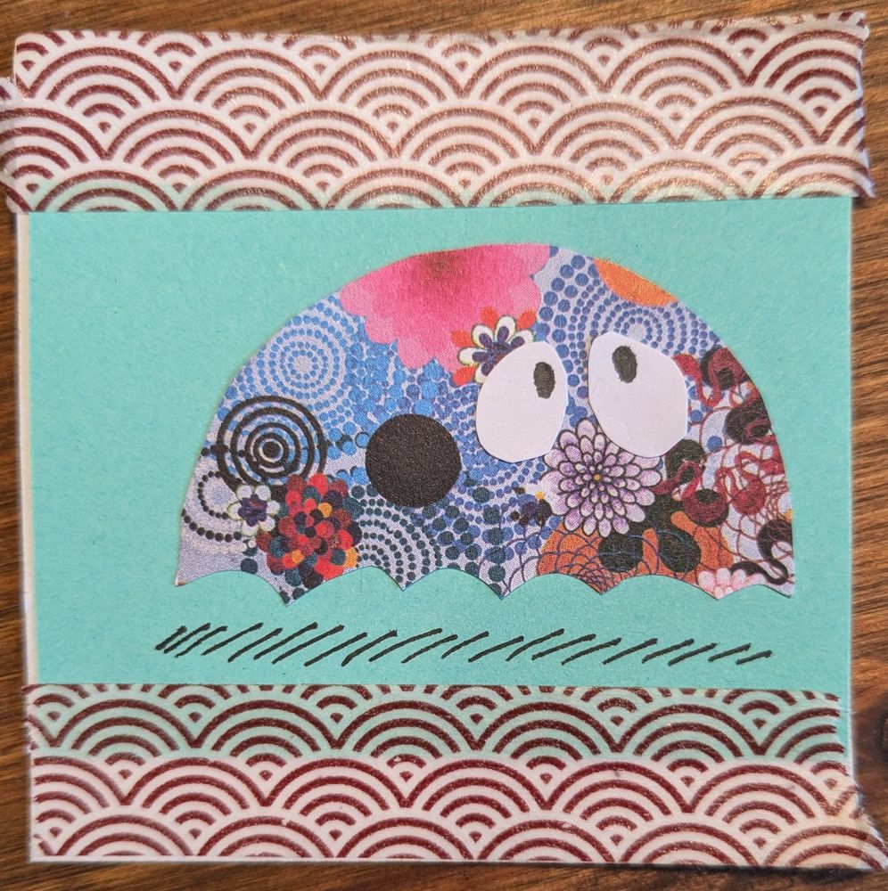 One of many examples of small creatures made of collage material. A colourful, concerned ghost