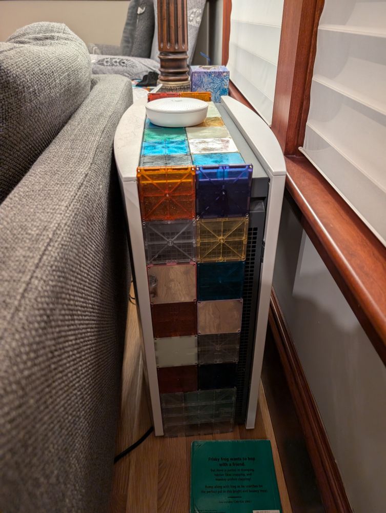 Blue Air air purifier behind a sofa with colorful magnetiles covering the top but also the air intake.