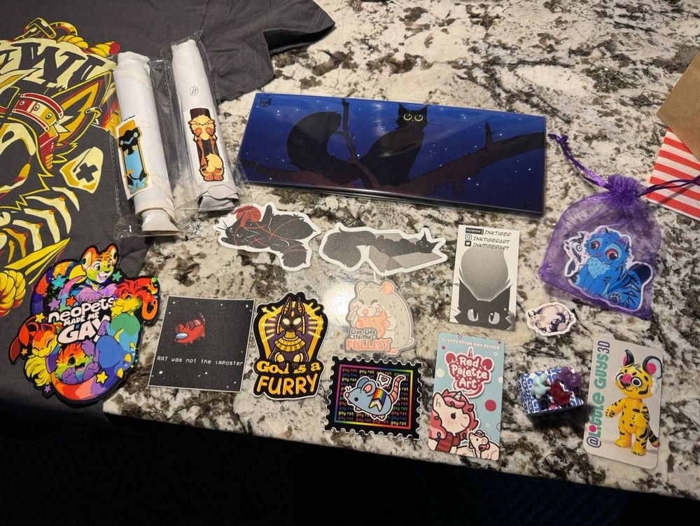 A display of merchandise from various vendors at a furry convention.