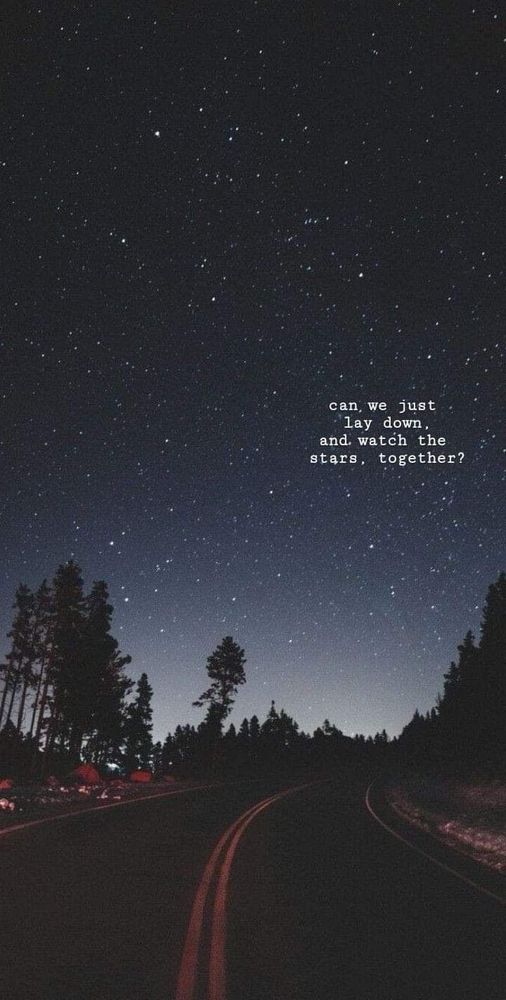 A picture of a road at night with a starry night sky above it and white text in the sky reading: “can we just lay down and watch the stars together?”